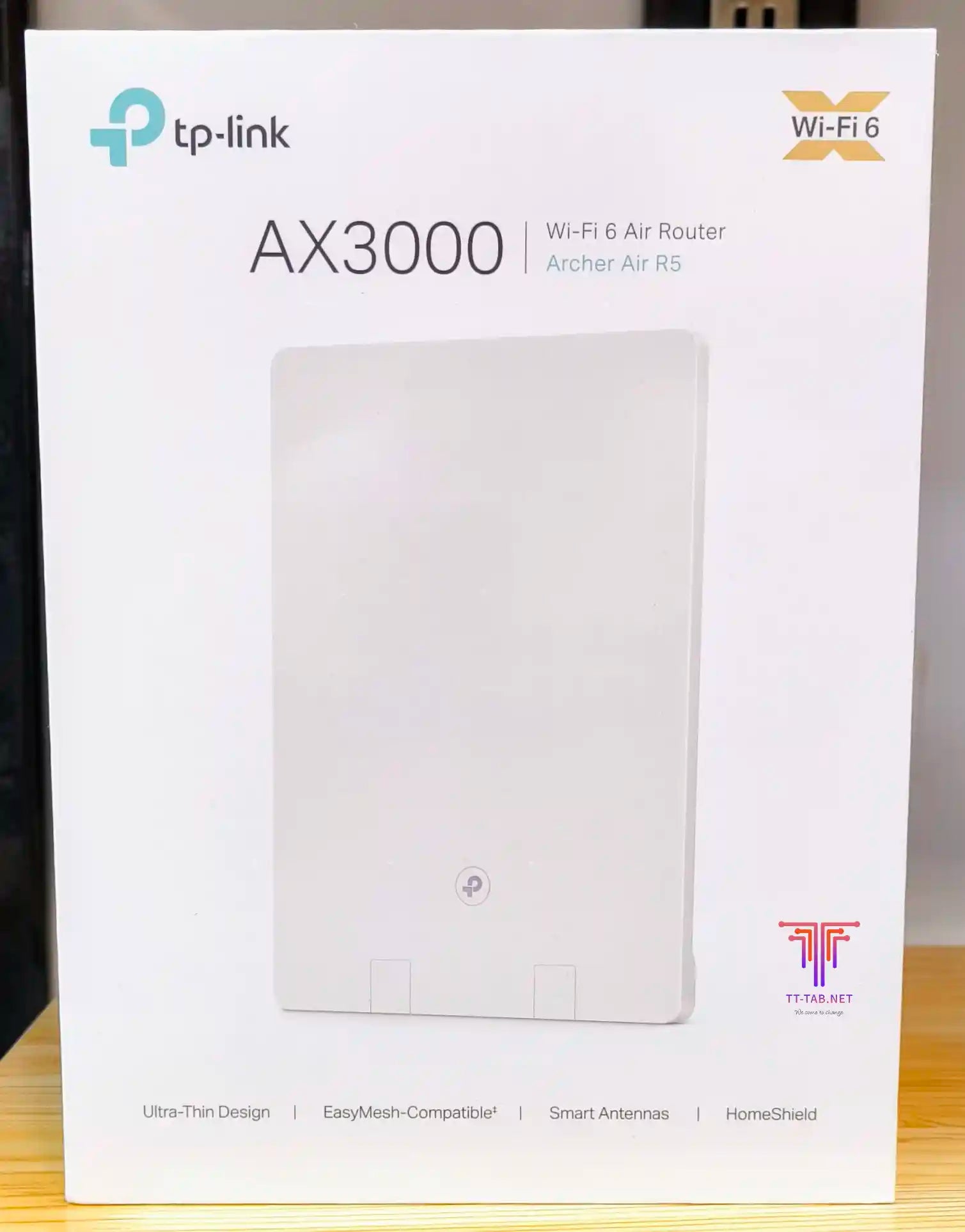 TP-Link Wi-Fi 6 router packaging on a wooden surface