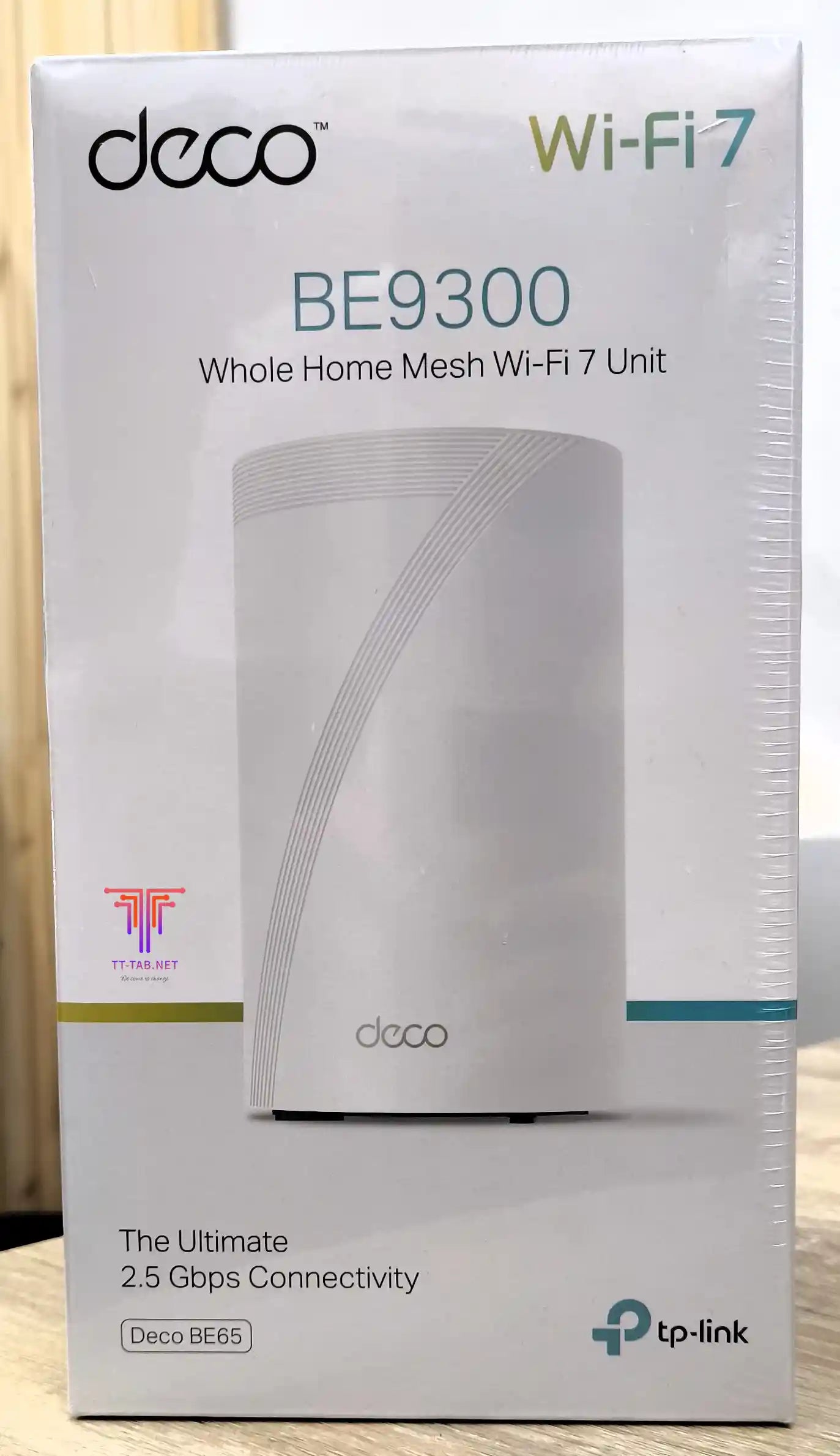 TP-Link Deco BE9300 Wi-Fi 7 router packaging on a wooden surface