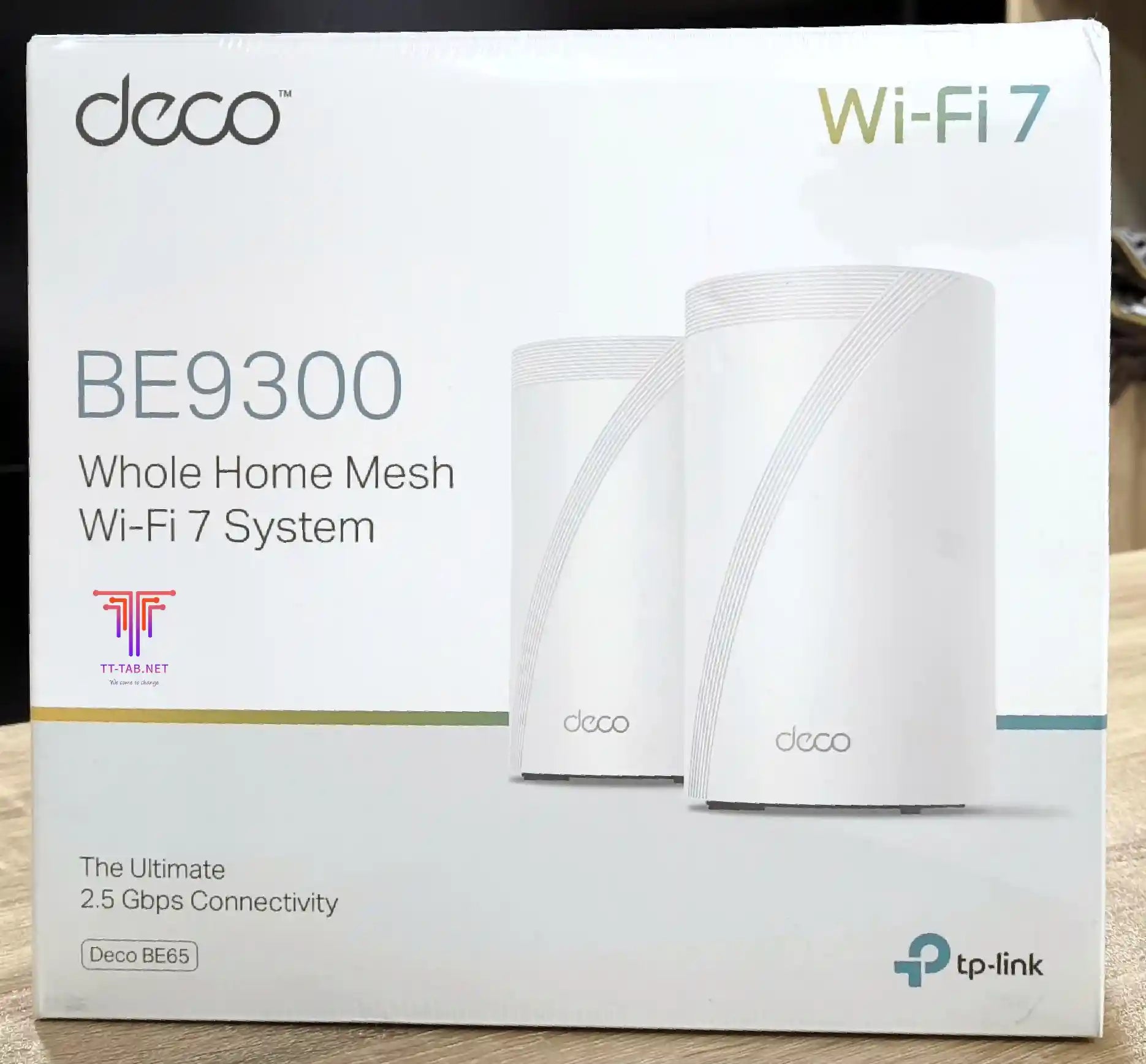 Box of TP-Link Deco BE9300 Whole Home Mesh Wi-Fi 7 System on a wooden surface