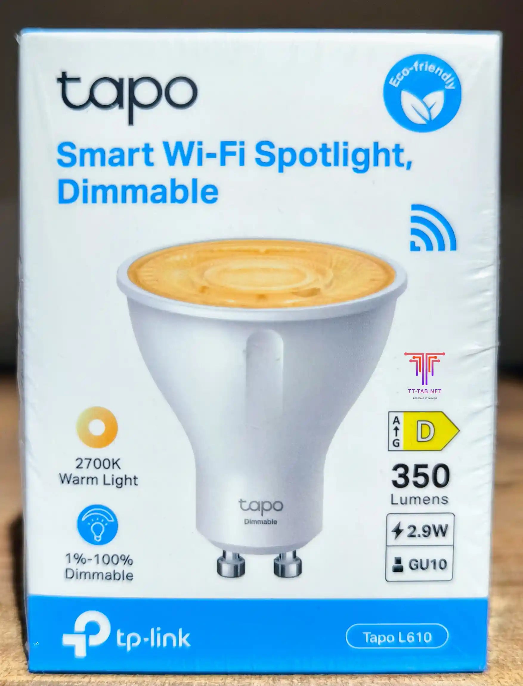 Box of TP-Link Tapo L610 smart Wi-Fi spotlight on a wooden surface