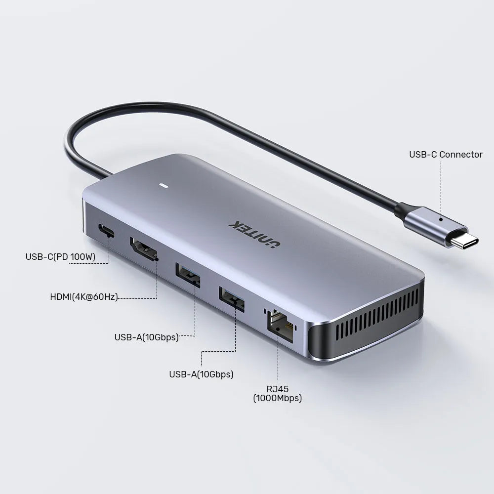 Silver USB-C hub with multiple ports on a light gray background