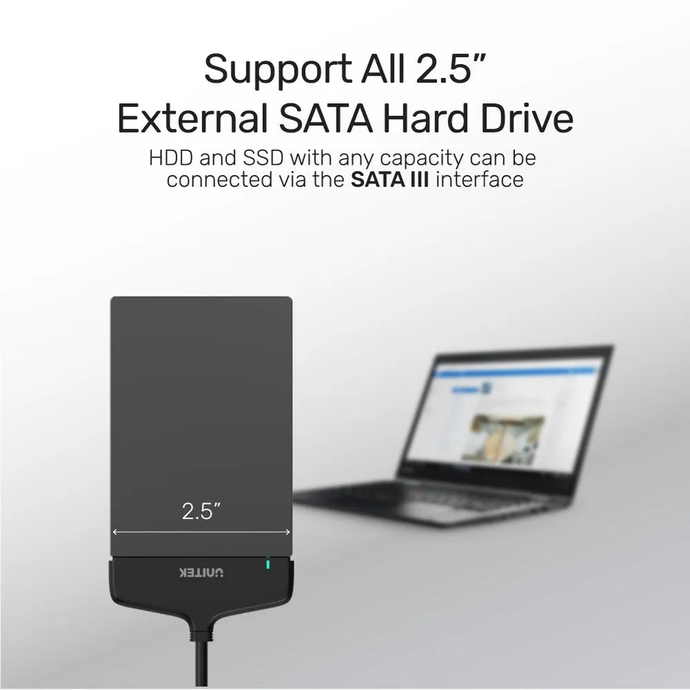 External SATA hard drive adapter with laptop in the background on a white background